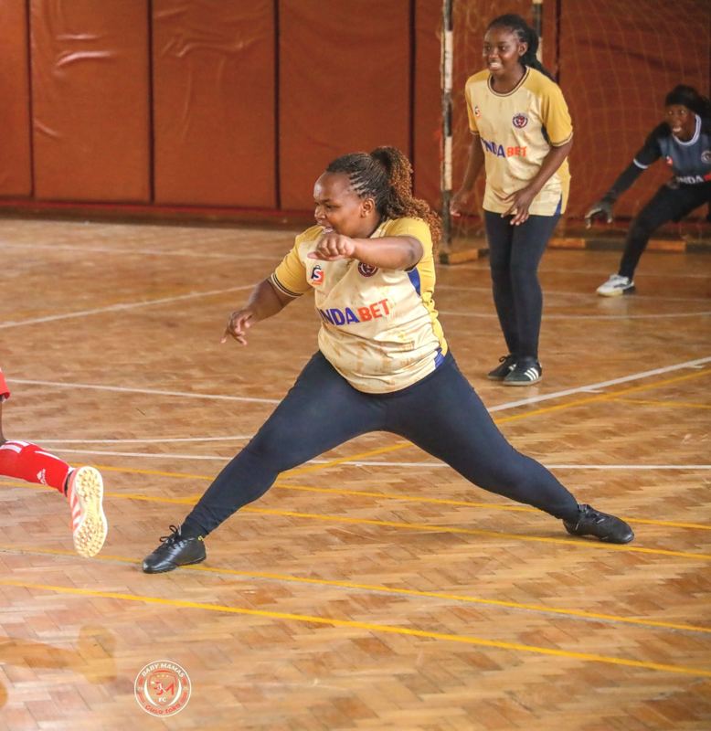 A Baby Mamas player stretching for the ball in futsal